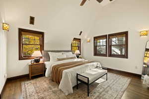 Bedroom with ceiling fan, dark hardwood / wood-style floors, and high vaulted ceiling