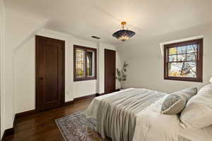 Bedroom featuring dark hardwood / wood-style flooring and vaulted ceiling