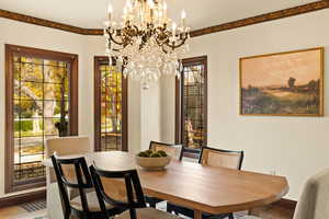 Dining room with hardwood / wood-style flooring and an inviting chandelier