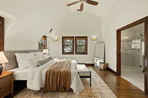 Bedroom with ceiling fan, dark hardwood / wood-style flooring, high vaulted ceiling, and ensuite bath