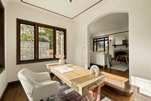 Dining room with a brick fireplace and dark wood-type flooring