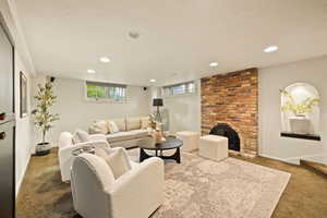 Living room with a fireplace and carpet floors