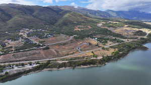 Birds eye view of property with a water and mountain view