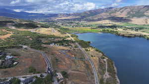 Drone / aerial view featuring a water and mountain view