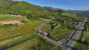 Aerial view of property and surrounding area featuring mountains