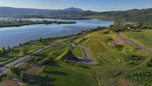 Aerial view of property's location featuring a water and mountain view