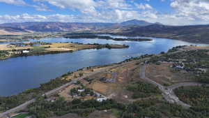 Drone / aerial view featuring a water and mountain view