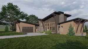 View of front of property featuring a garage and a front yard