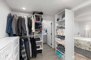 Spacious closet with light wood-type flooring