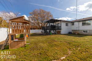 View of yard with a playground and a wooden deck