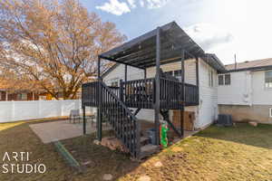 View of home's exterior with a yard, a patio, central AC unit, and a wooden deck