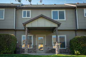 Back of townhome featuring covered patio looking onto courtyard