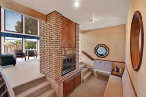 Conversation pit with fireplace off of the living room.