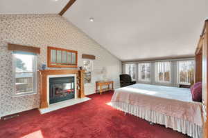 Huge Main bedroom suite with lots of natural light, sitting area, fireplace, sunken tub, and 2 closets.