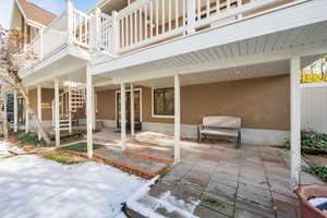 Snow covered patio with a balcony