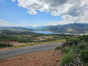 Property view of mountains featuring a water view