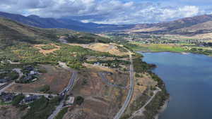 Birds eye view of property with a water and mountain view