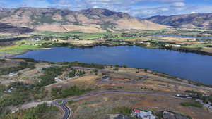 Drone / aerial view featuring a water and mountain view