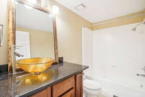 Full bathroom with designer raised sink, tiled floor