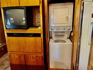 Washroom featuring stacked washer and clothes dryer