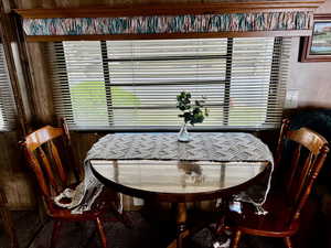 Dining room featuring wood walls