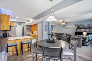 Tiled dining room featuring ceiling fan and sink