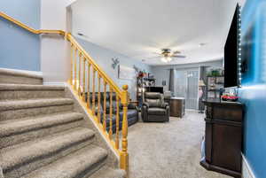 Living room with carpet and ceiling fan