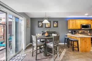 Tiled dining space featuring a textured ceiling