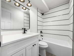 Full bathroom with shower / washtub combination, vanity, and toilet