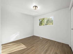 Empty room featuring hardwood / wood-style floors