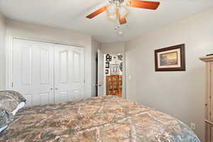 Bedroom featuring ceiling fan and a closet