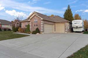 View of front of house with a garage and a front lawn