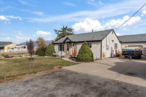 View of front of house with a front lawn and a garage