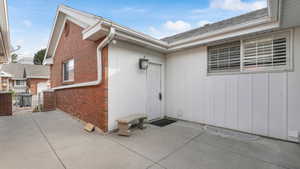 Doorway to property with a patio area