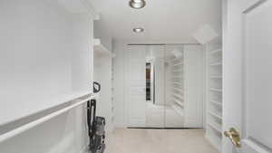 Spacious closet with light colored carpet