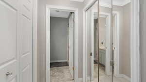 Corridor with light tile patterned floors and crown molding