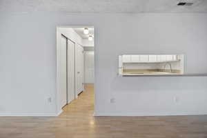 Dining area includes breakfast bar space, room for dining table too, view into hallway leading to bedrooms