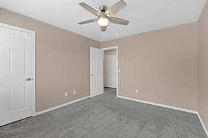 Unfurnished bedroom with carpet floors and ceiling fan