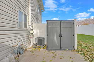 View of outbuilding with a mountain view and cooling unit