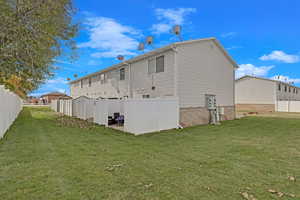 Rear view of property with a lawn