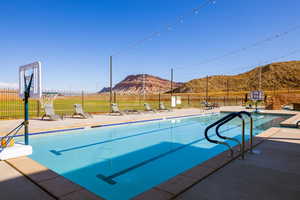 View of pool with a mountain view and a patio area