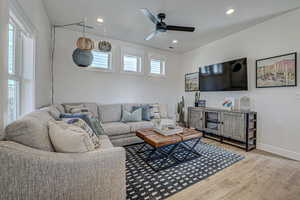 Living room featuring ceiling fan and hardwood / wood-style flooring