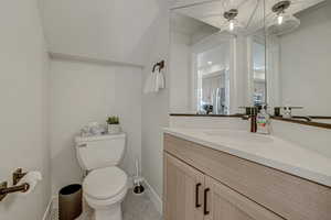 Bathroom featuring tile patterned flooring, vanity, and toilet