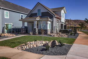 View of front of property featuring a porch and a front lawn