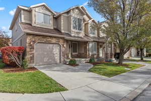 View of front of home with a front yard and a garage