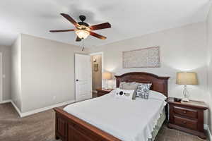 Carpeted bedroom with ceiling fan