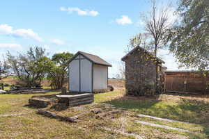 View of yard with a storage unit