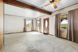 Interior space featuring ceiling fan and a wealth of natural light