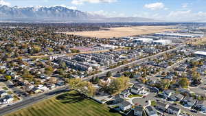 Birds eye view of property featuring an airport and a mountain view