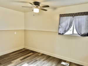 Empty room featuring ceiling fan and hardwood / wood-style flooring